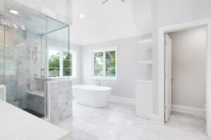 luxury-bathroom-with-white-marble-standalone-tub-and-shower-enclosure
